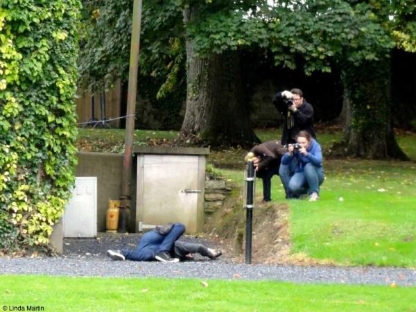 Photography class -- this is a photo of people taking photos of someone taking a photo. Yep.