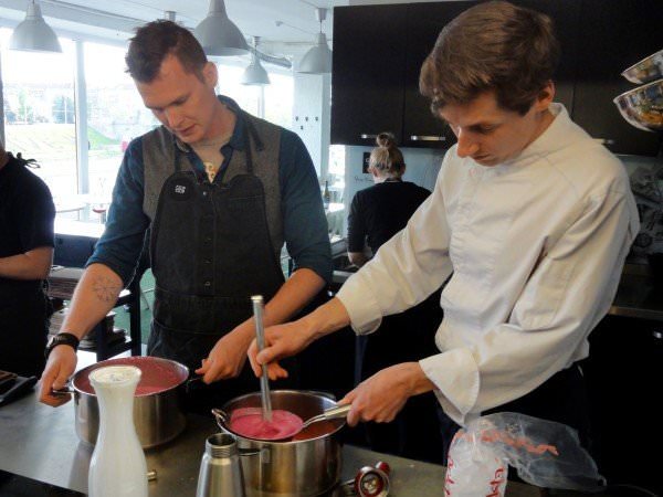 Two men stir pots at Ciop Ciop.