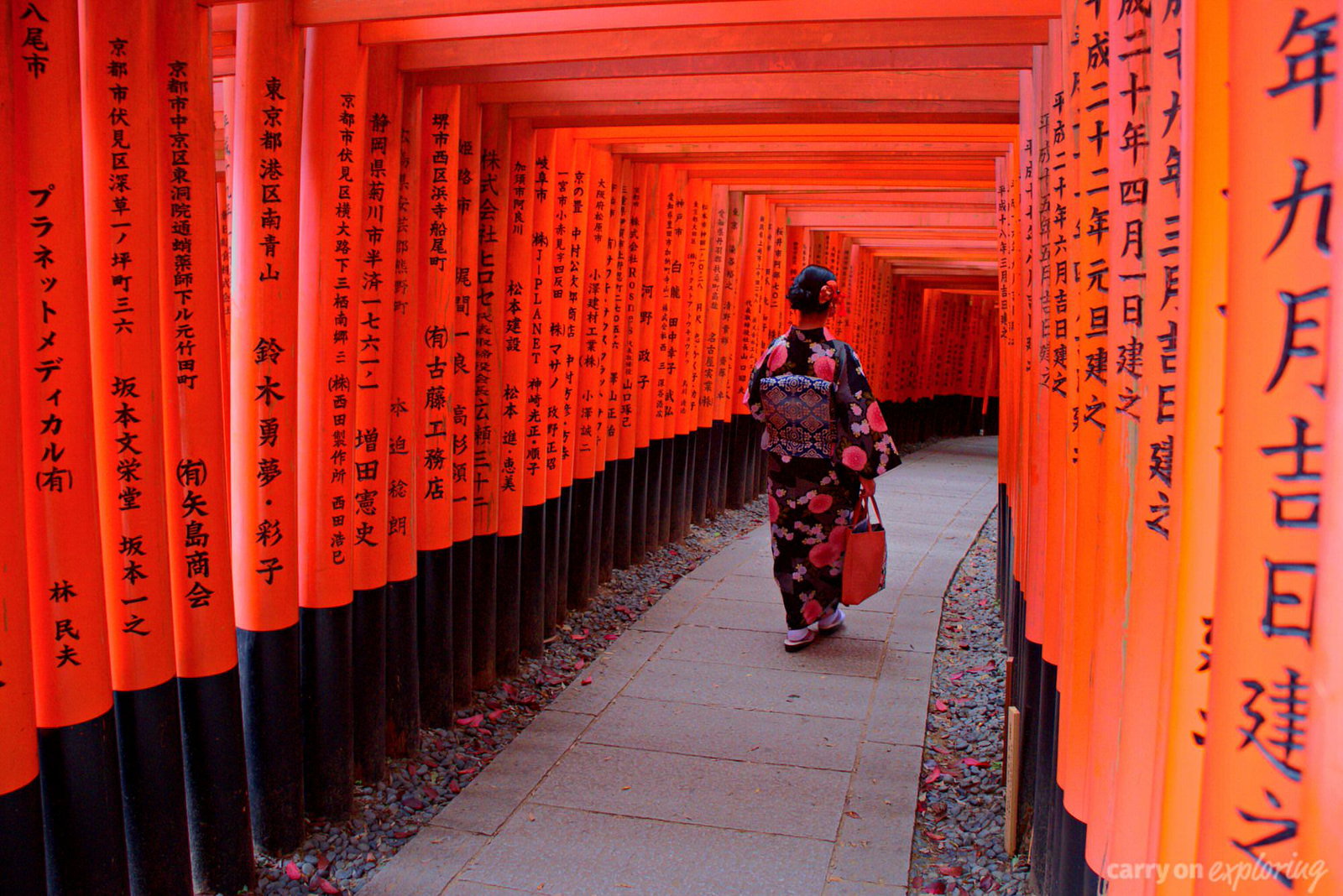 A geisha walking down a path in Kyoto, Japan. 