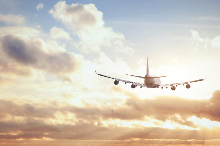 airplane in sunset sky