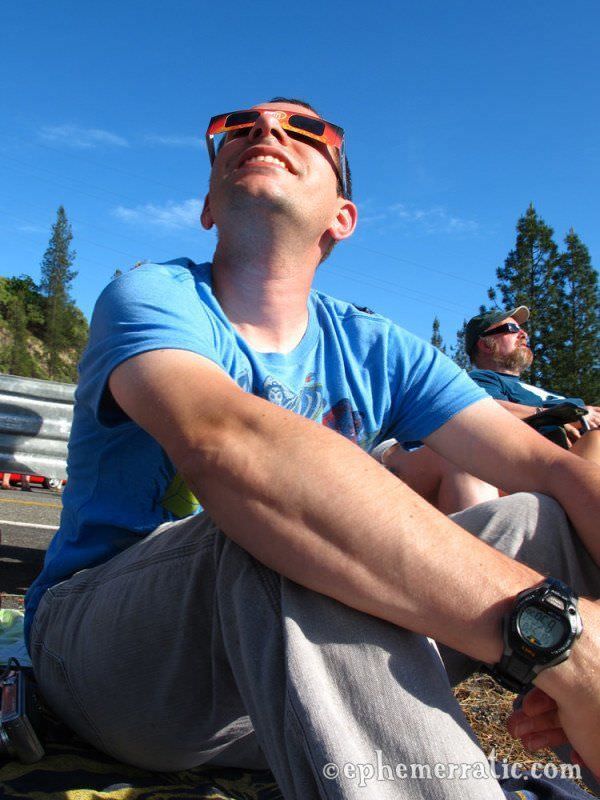 Meteorologist Joe Pollina watches the eclipse begin photo